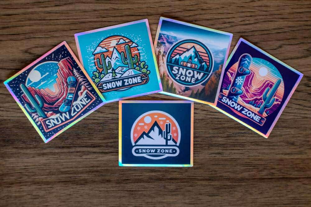 Water and UV proof Snow Zone stickers with outdoor adventure designs on wooden surface