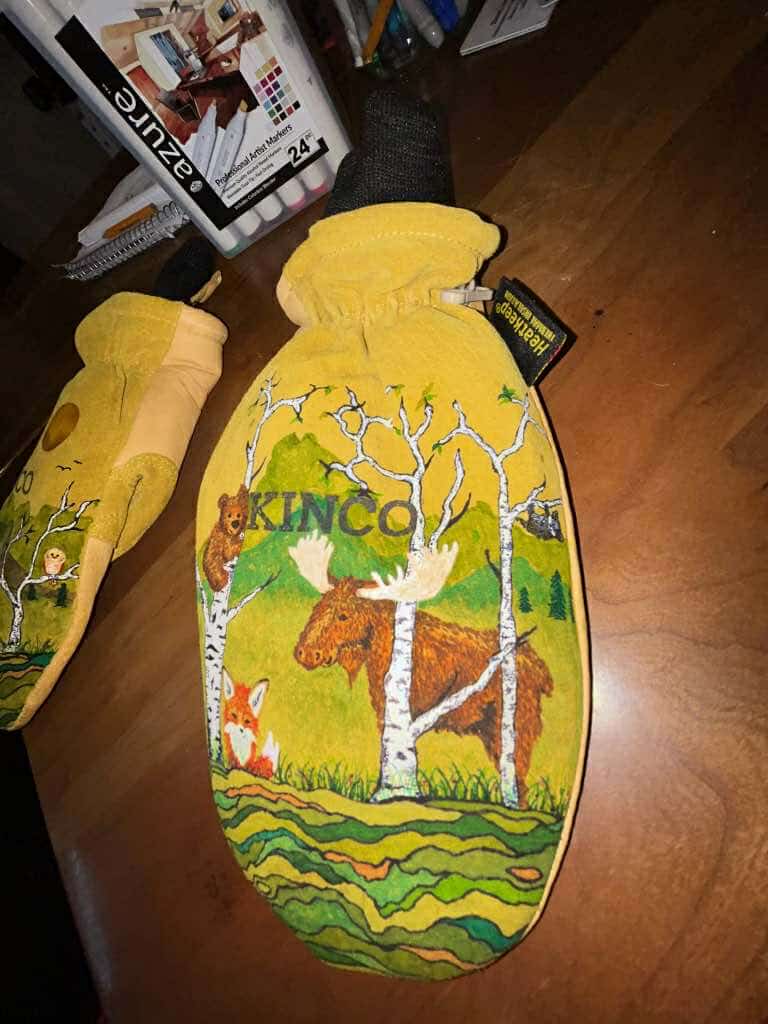 Yellow mittens with forest animal design and Kincos By Katie branding for custom orders
