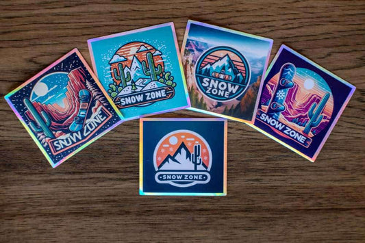 Water and UV proof Snow Zone stickers with outdoor adventure designs on wooden surface