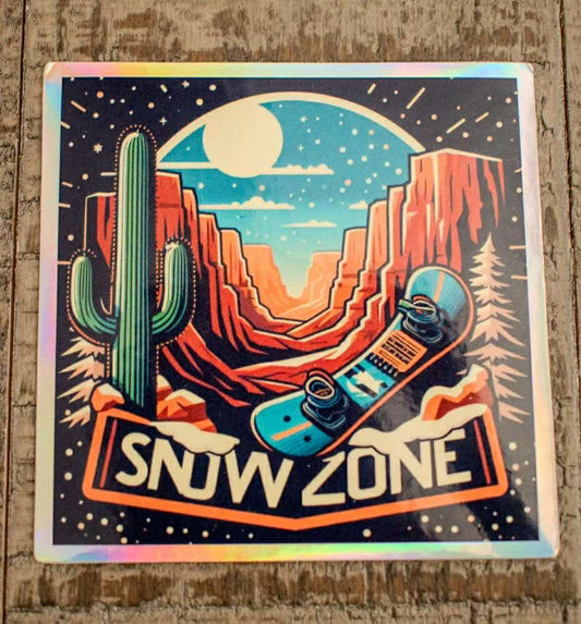 Sticker featuring a desert night scene with cactus, red rock cliffs, full moon, snowboard, and "Snow Zone" text